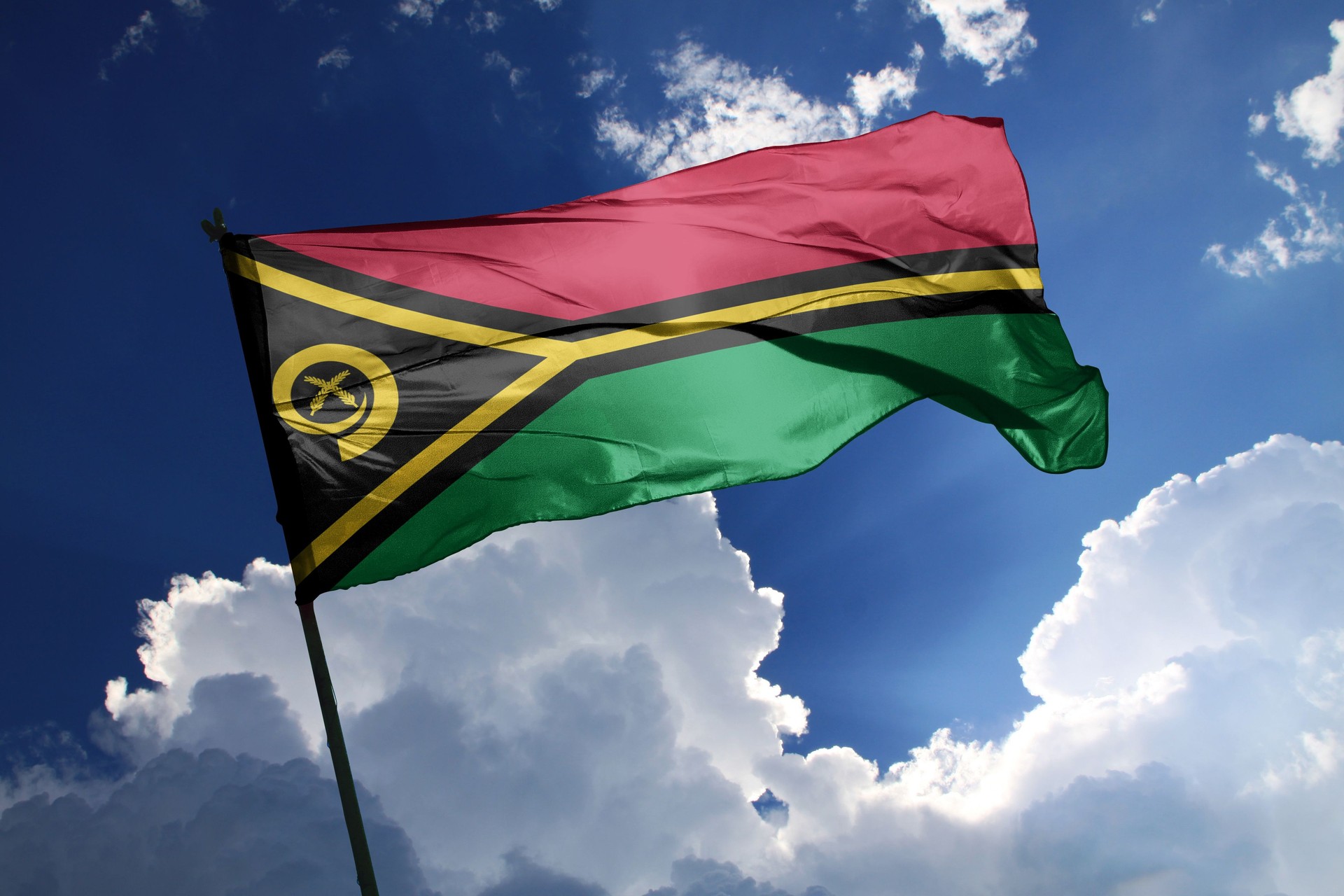 national flag of Vanuatu waving in the wind on a clear day.